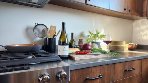 Anaba Home Cooking Kitchen with stove, bottle of Anaba Pinot, and the ingredients for Italian Dinner on the countertop